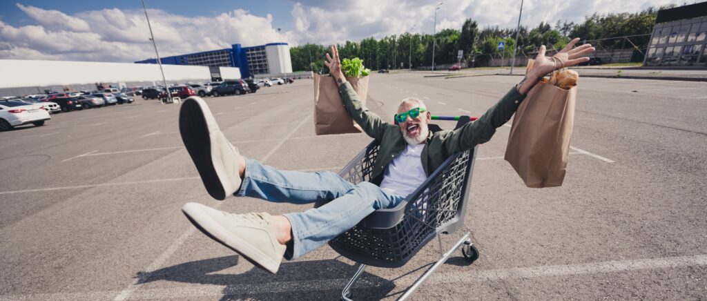 senior having fun ride a shopping cart