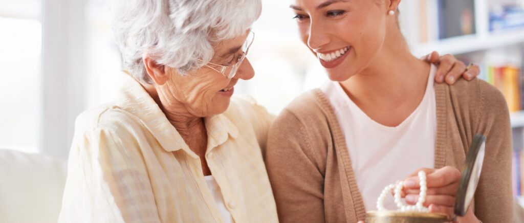 mom giving heirloom necklace to daughter