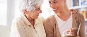 mom giving heirloom necklace to daughter