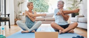 senior couple doing yoga at home