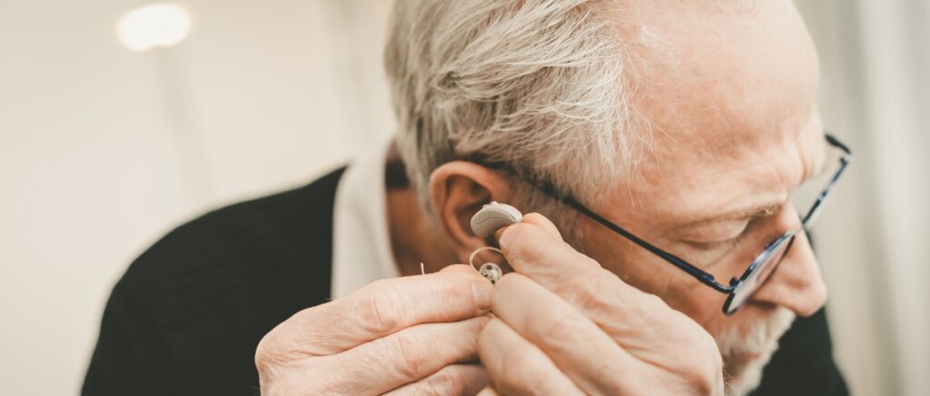 Man putting hearing aids