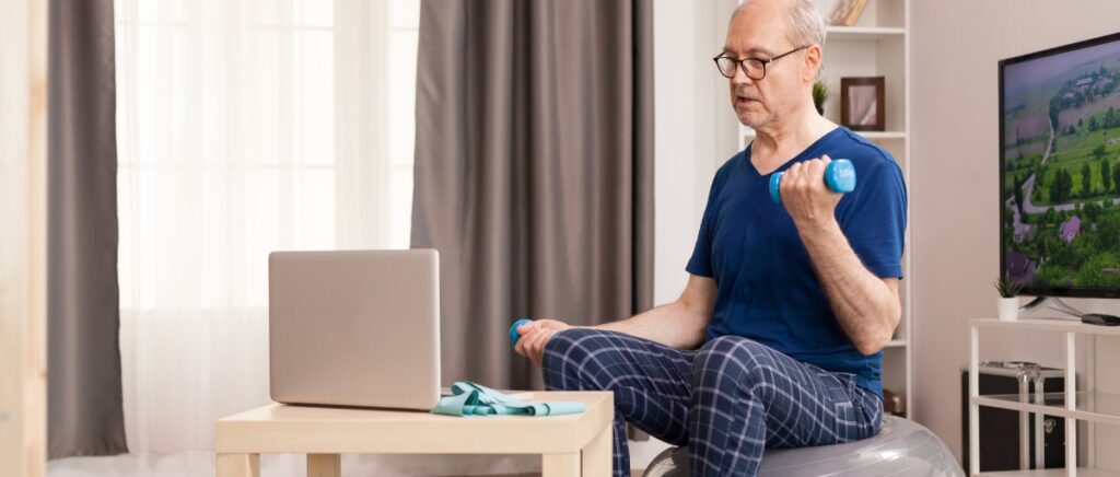 senior man watching online exercise