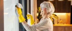 senior woman cleaning windows