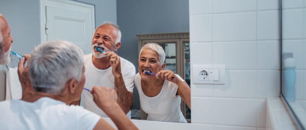 couple brushing teeth together