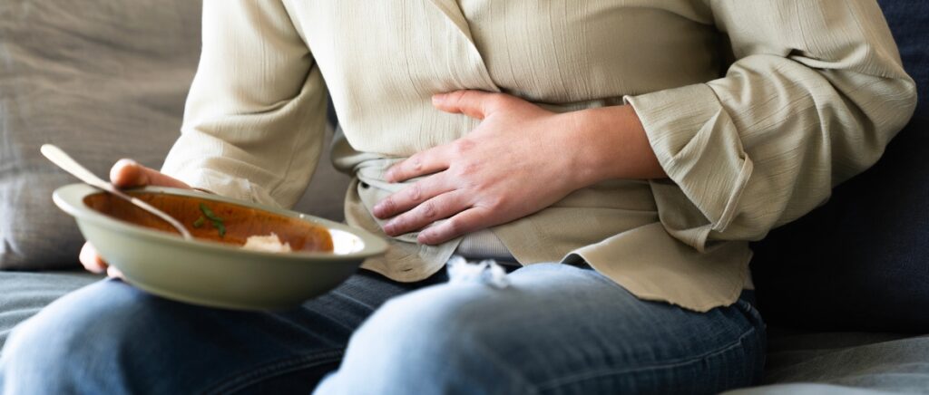Woman with bloating and abdominal pain
