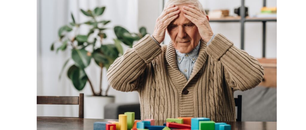 senior man touching his head