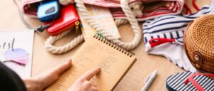 A woman checking the list of things to pack for a cruise.