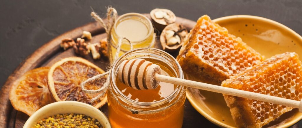 Different kinds of honey on a wooden platter