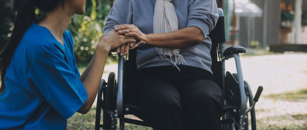 Elderly woman taken care by a caretaker.