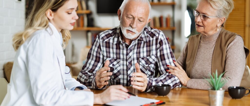 Insurer discussing different Medicare plans with a senior couple.