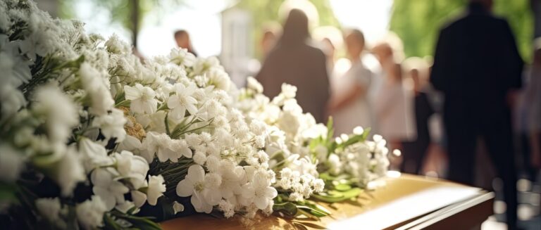 Coffin decorated with white flowers.