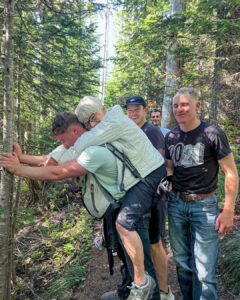 U.S. Air Force. (2024, August 28). Airman Troy May carries Ursula Bannister, 79, to safety after she broke her leg while hiking in Ashford, Washington [Photograph]. U.S. Air Force.