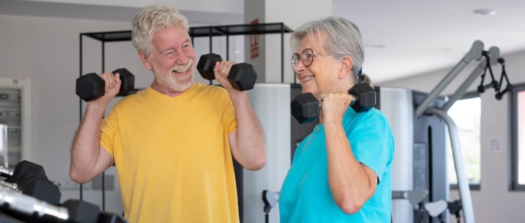 Happy couple using exercise equipment for seniors