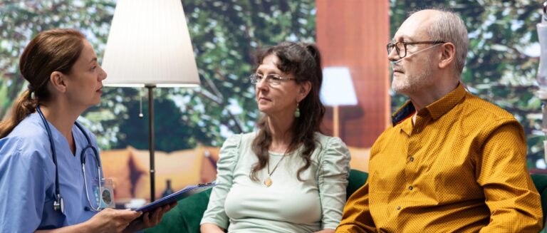 Senior couple discussing with caregiver how much they make