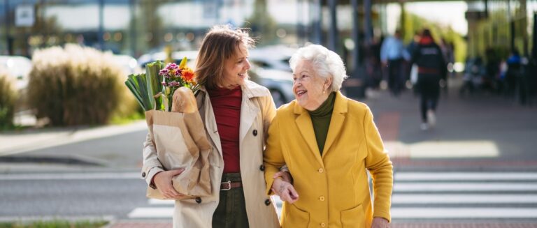 Senior woman grocery shopping with an errand runner