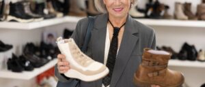 Senior woman thinking of which shoes to buy.