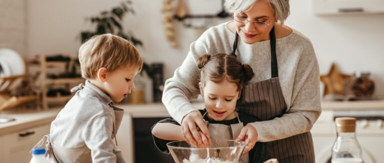 grandchildren cook in the kitchen with grandmother