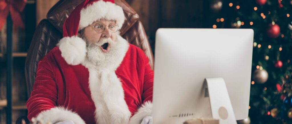 A surprised Santa in front of a computer