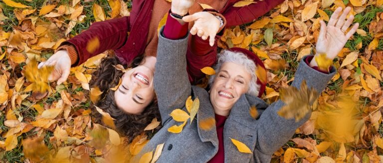 Women enjoying autumn leaves