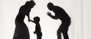 Silhouettes of quarreling parents and little child